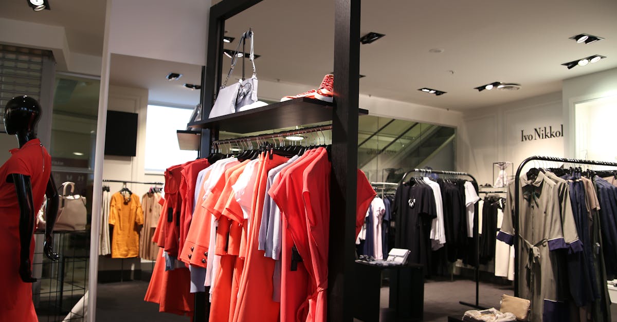 Discover a chic fashion boutique showcasing a variety of colorful clothes on elegant racks.